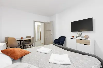 a bedroom with a bed and a table with chairs at 2 bedrooms apartment near the metro in Prague