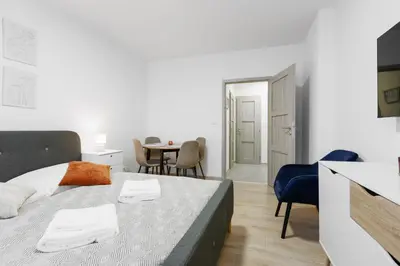 a bedroom with a bed and a table with chairs at 2 bedrooms apartment near the metro in Prague