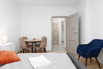a room with a bed and a table and chairs at 2 bedrooms apartment near the metro in Prague
