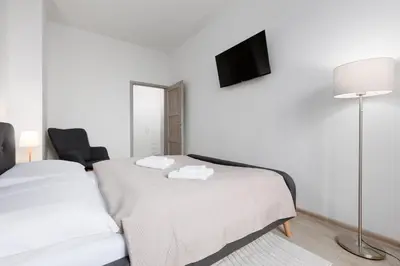 a bedroom with two beds and a tv on the wall at 2 bedrooms apartment with kitchen near the subway in Prague