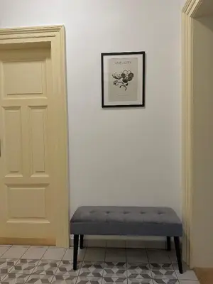 a bench sitting in a room next to a door at Útulný byt v centru Prahy in Prague