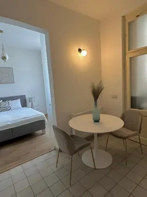 a room with a table and chairs and a bed at Útulný byt v centru Prahy in Prague