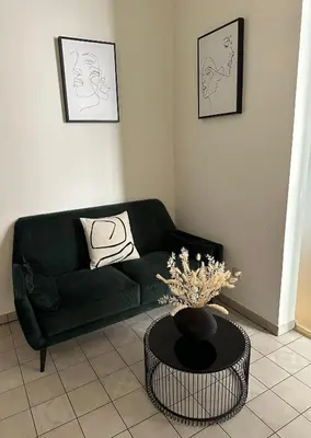 a living room with a green couch and a table at Útulný byt v centru Prahy in Prague