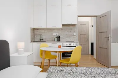 a kitchen with a table and yellow chairs at Quiet apartment with kitchen near the metro in Prague