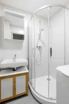 a bathroom with a shower and a sink at Quiet apartment with kitchen near the metro in Prague