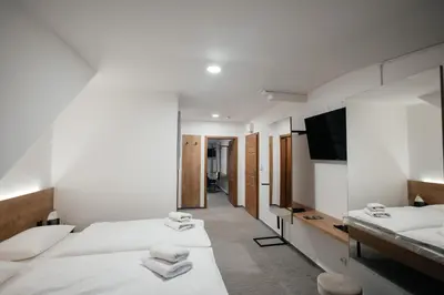 a hotel room with two beds and a flat screen tv at Golden Golem hotel & Spa in Prague