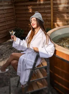 a woman sitting in a chair holding a glass of wine at Golden Golem hotel & Spa in Prague
