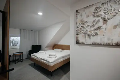 a bedroom with a bed and a painting on the wall at Golden Golem hotel & Spa in Prague