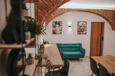 a living room with a green couch and a table at Zizkoff apartments in Prague