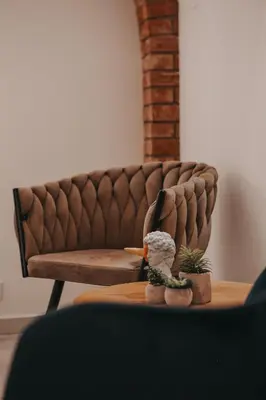 a living room with a couch and a figurine on a table at Zizkoff apartments in Prague