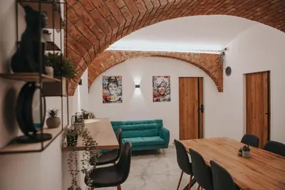 a living room with a green couch and a table at Zizkoff apartments in Prague