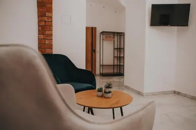 a living room with a couch and a table at Zizkoff apartments in Prague