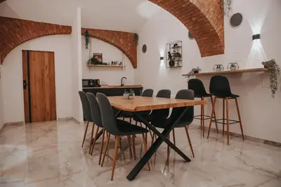 a dining room with a wooden table and chairs at Zizkoff apartments in Prague
