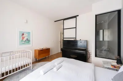 a bedroom with a bed and a crib at Gallery Apartment in Prague