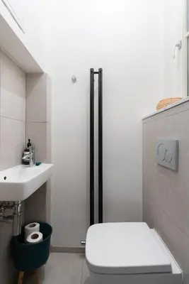 a bathroom with a toilet and a sink at Gallery Apartment in Prague