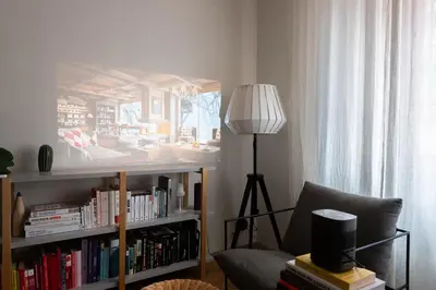 a living room with a couch and a book shelf with books at Gallery Apartment in Prague