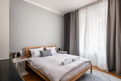 a bedroom with a bed with two towels on it at Gallery Apartment in Prague