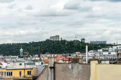 a view of a city with buildings and trees at Top Floor Industrial Apartment with a River View in Prague
