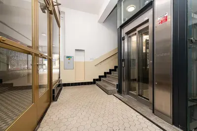 an empty hallway with doors and stairs in a building at Top Floor Industrial Apartment with a River View in Prague