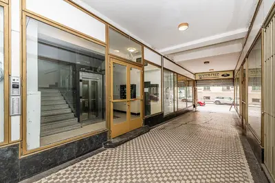 an empty hallway of a building with glass windows at Top Floor Industrial Apartment with a River View in Prague