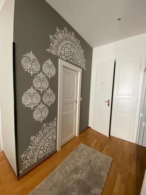 a room with a door and a wall with a mural at Golem in Prague
