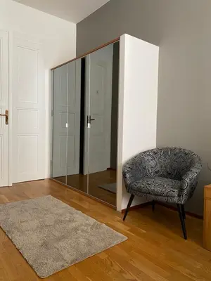 a room with a mirror and a chair and a rug at Golem in Prague
