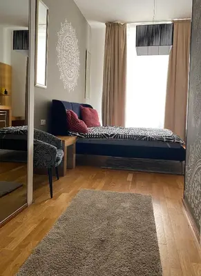 a living room with a couch and a window at Golem in Prague