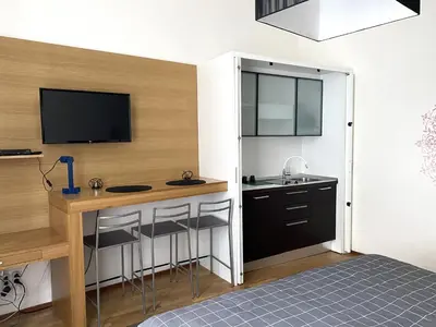 a kitchen with a counter and a sink and a desk at Golem in Prague