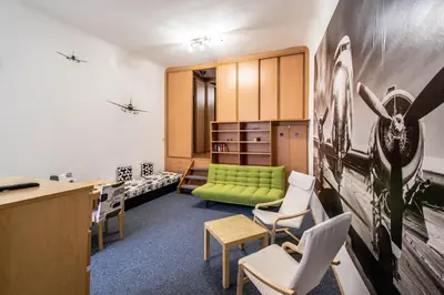 an office with a green couch and chairs at Jewish Synagogue Ruterra Suite in Prague