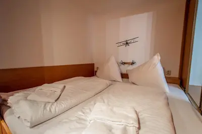 a large white bed with two pillows on it at Jewish Synagogue Ruterra Suite in Prague
