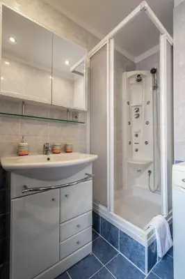 a bathroom with a sink and a shower at Jewish Synagogue Ruterra Suite in Prague