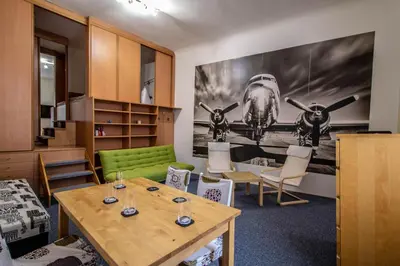 a room with a table and chairs and a plane on the wall at Jewish Synagogue Ruterra Suite in Prague