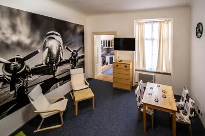 a living room with a plane mural on the wall at Jewish Synagogue Ruterra Suite in Prague