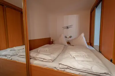 a large white bed in a room with a mirror at Jewish Synagogue Ruterra Suite in Prague
