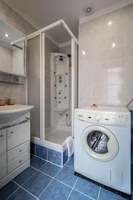 a washing machine in a bathroom with a shower at Jewish Synagogue Ruterra Suite in Prague