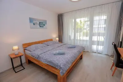 a bedroom with a bed with blue pillows on it at Modern Apartment • Garden • Near The City Center in Prague