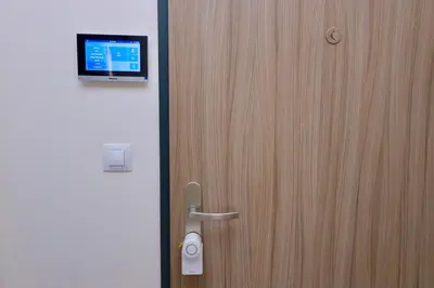 a wooden door with a tv on top of it at Modern Apartment • Garden • Near The City Center in Prague