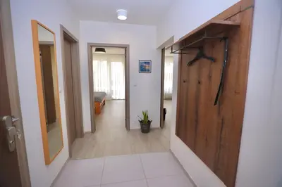 a hallway with a wooden door in a room at Modern Apartment • Garden • Near The City Center in Prague