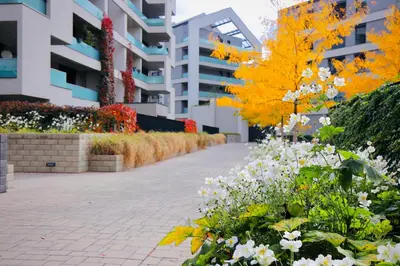 a garden of flowers in front of a building at Modern Apartment • Garden • Near The City Center in Prague