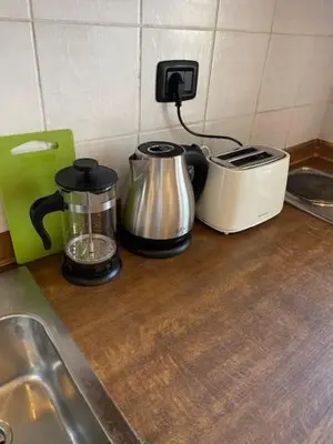 a kitchen counter with two coffee makers and a toaster at Vitkova apartment with balcony in Prague