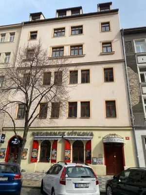 a white car parked in front of a building at Vitkova apartment with balcony in Prague