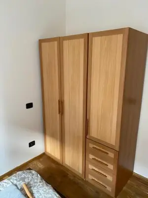 a bedroom with two wooden cabinets and a bed at Vitkova apartment with balcony in Prague