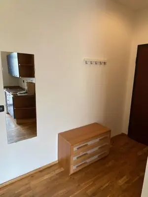 a white room with a table and a mirror at Vitkova apartment with balcony in Prague