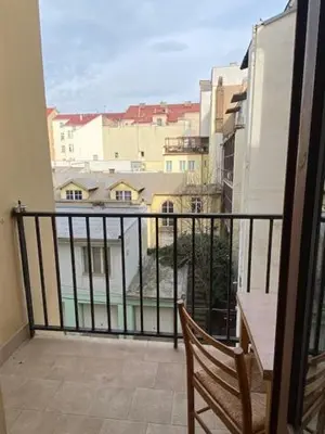 a balcony with a bench and a view of a city at Vitkova apartment with balcony in Prague