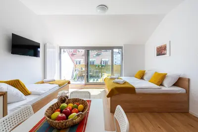 a living room with a bowl of fruit on a table at Libero Apartments in Prague