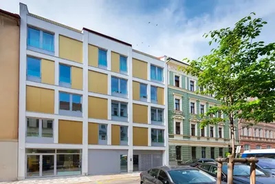 an apartment building with yellow and blue windows at Libero Apartments in Prague