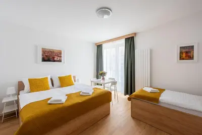 a bedroom with two beds and a window at Libero Apartments in Prague