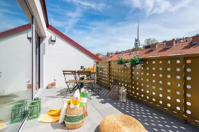 a balcony with a table and a fence at Libero Apartments in Prague