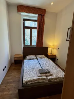 a small bedroom with a bed with a window at 1 Bed Flat - Sleeps 2 - Pets - Smoking on terrace in Prague