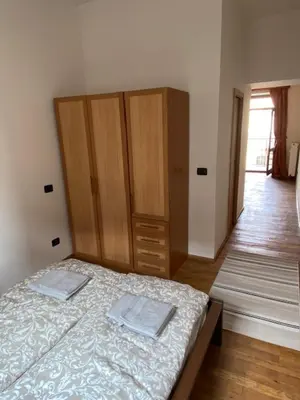 a bedroom with a bed and a wooden cabinet at 1 Bed Flat - Sleeps 2 - Pets - Smoking on terrace in Prague